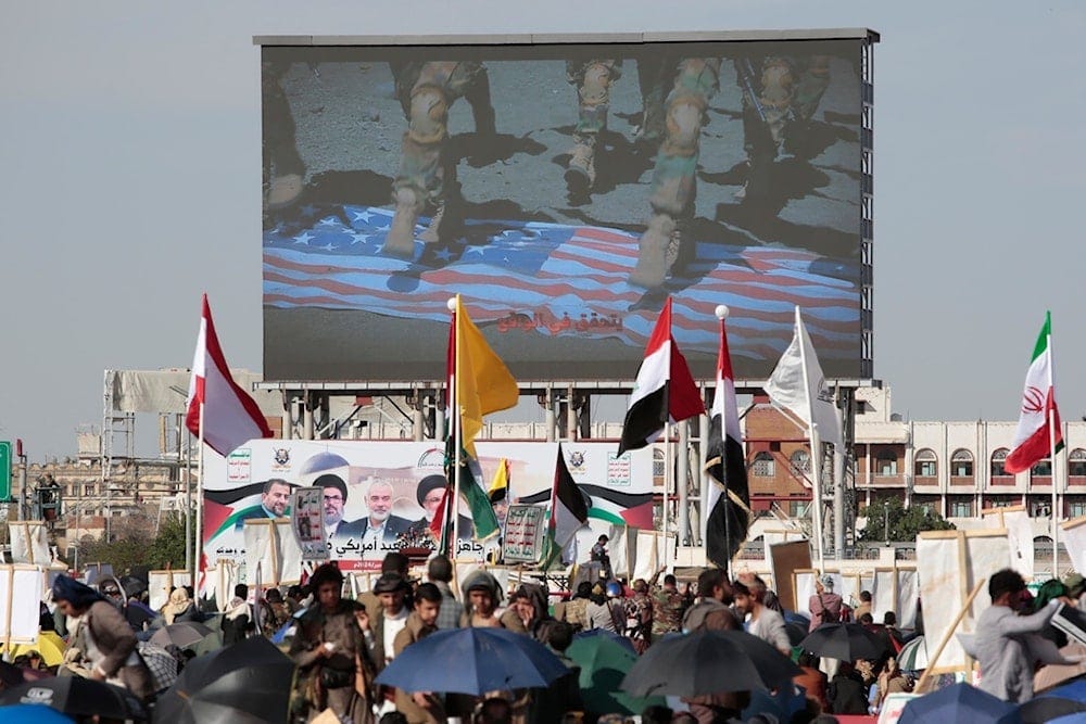 Yemenis shout slogans as a screen displays soldiers stepping on an American flag during a pro-Palestine rally in Sanaa, Yemen, Friday, Nov. 1, 2024. (AP) Yemenis shout slogans as a screen displays soldiers stepping on an American flag during a pro-Palestine rally in Sanaa, Yemen, Friday, Nov. 1, 2024. (AP)