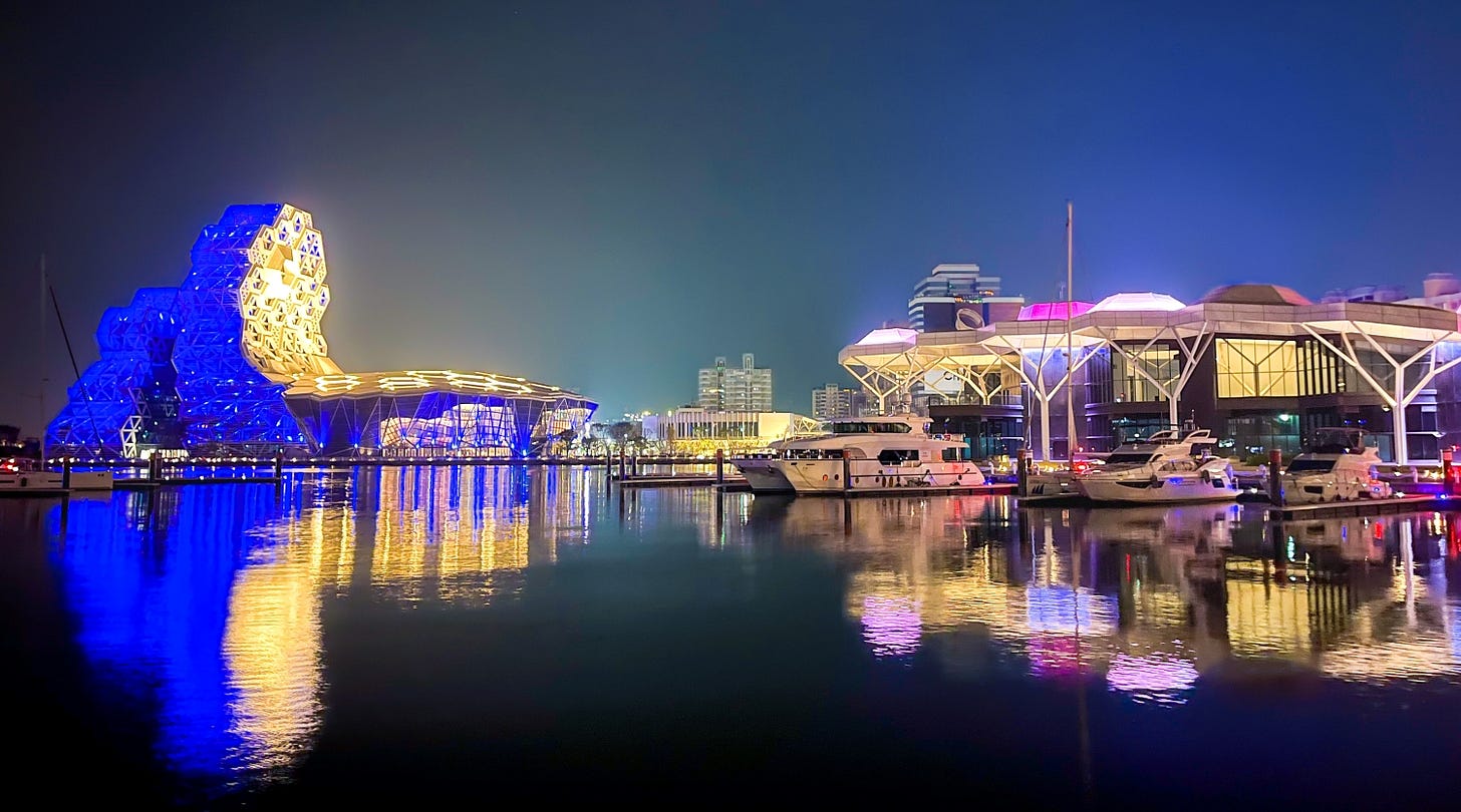 The lights of the Kaohsiung Music Center and the Kaohsiung Yacht Club are reflected in the waters of the city’s marina The lights of the Kaohsiung Music Center and the Kaohsiung Yacht Club are reflected in the waters of the city’s marina