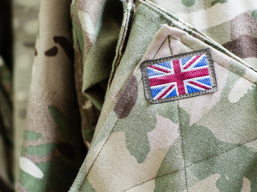 Union Jack flag on sleeve of British military camouflage uniform Union Jack flag on sleeve of British military camouflage uniform