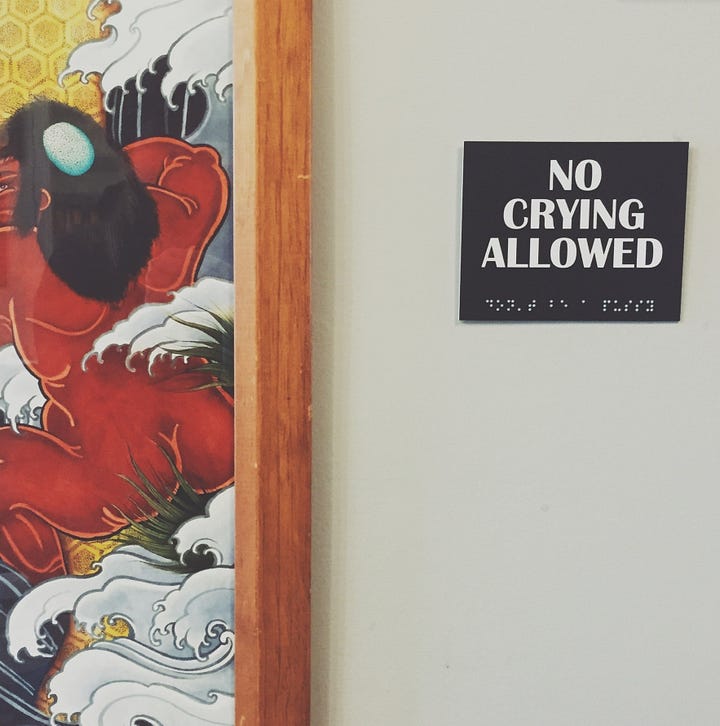Two photographs. On the left: a deer lies dead beside a highway in early summer light. Second photo: A sign at a local tattoo parlour warns clients: "No crying allowed." (Credit: Nancy Forde)