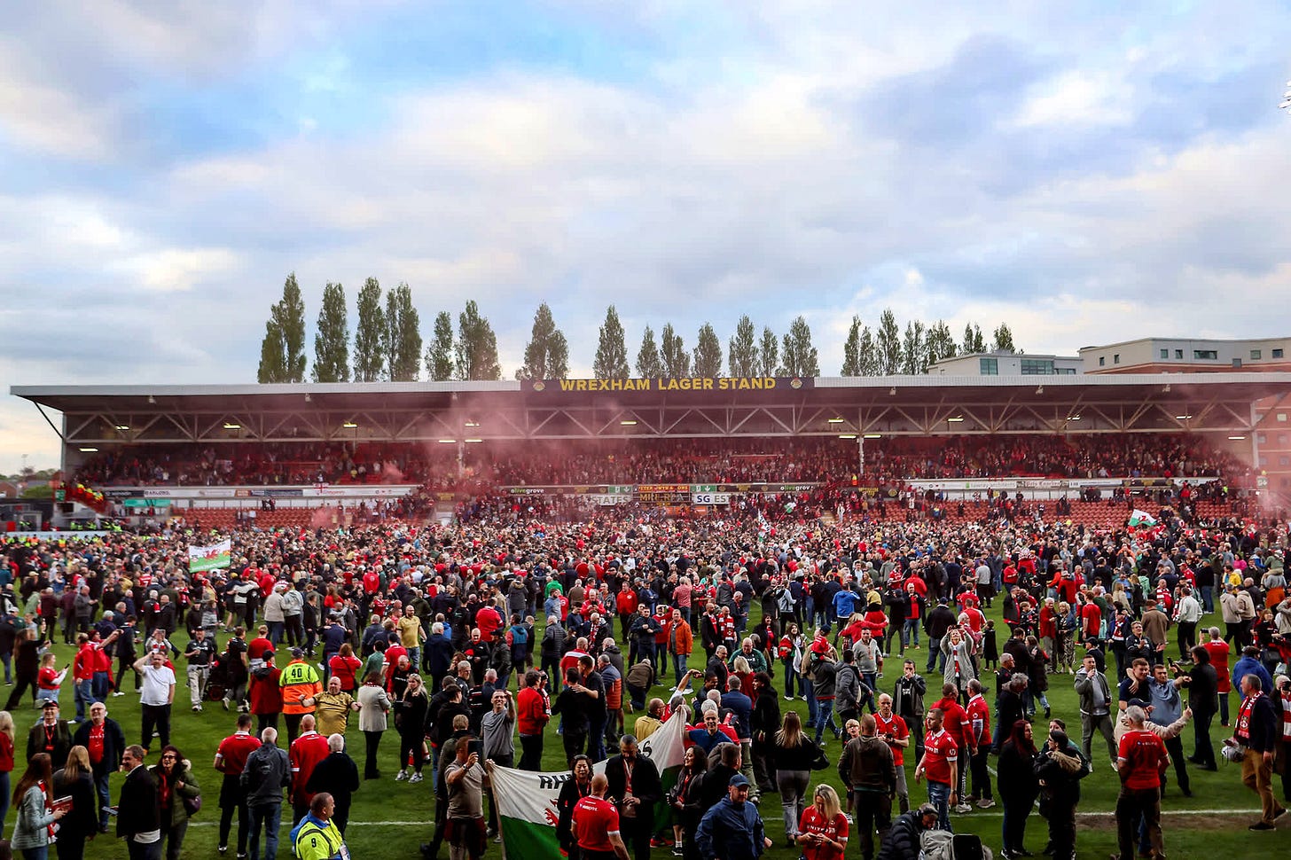 Wrexham fans rush the Racecourse Ground.