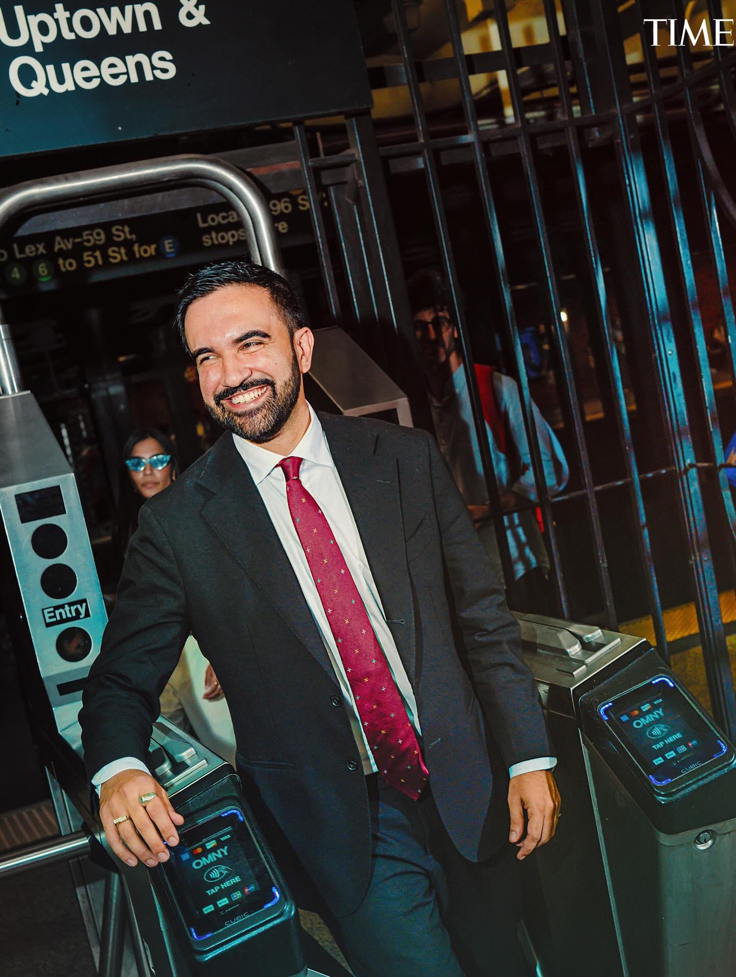 May be an image of ‎1 person, beard, turnstile, suit and ‎text that says '‎Uptown & Queens TIME Entry Entry OMNY 糖 여P KET OMNY 潮 ح PHBRE มสด‎'‎‎