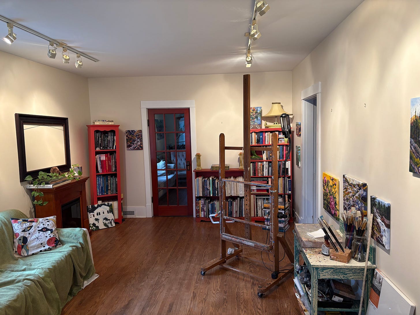 A view of Caprice's studio with no big paintings and an empty easel. 