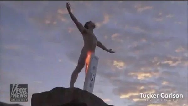 Bizarre screenshot from a Tucker Carlson video, showing a nude man on a mountaintop, his arms outstretched against a cloudy sky, as a device on a pedestal shines a bright light on his swimsuit area. Bizarre screenshot from a Tucker Carlson video, showing a nude man on a mountaintop, his arms outstretched against a cloudy sky, as a device on a pedestal shines a bright light on his swimsuit area.