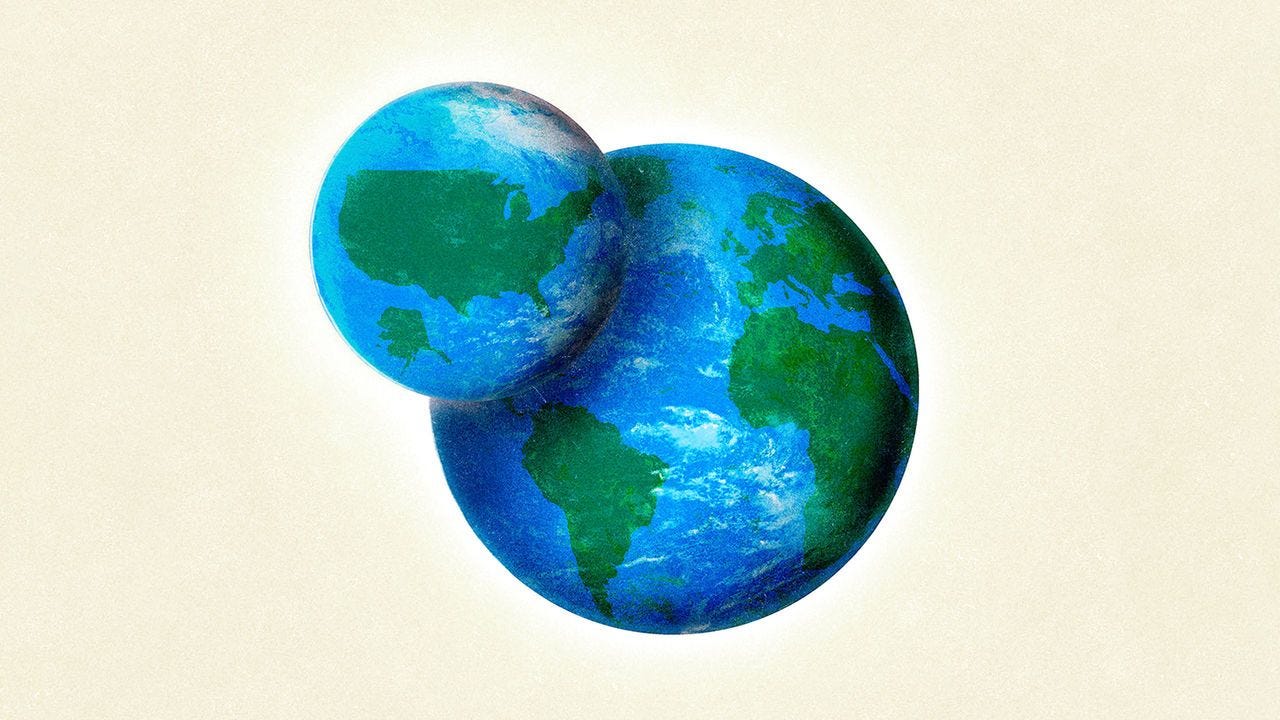 A globe with the American continent looming over another globe of the rest of the world