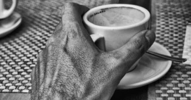 la mano de un chico sosteniendo una taza de café la mano de un chico sosteniendo una taza de café