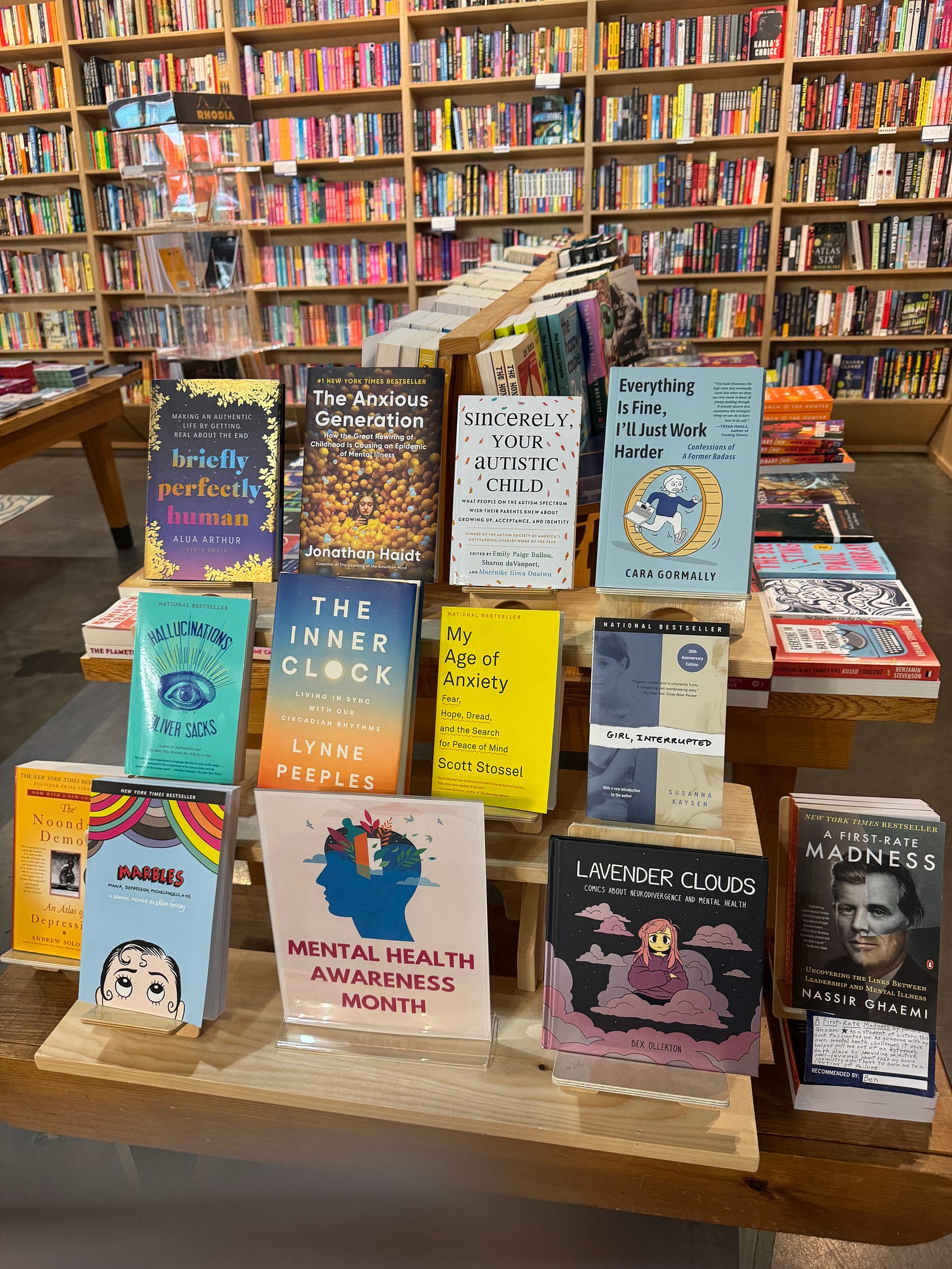 a display of books for mental health awareness month, including the author's book