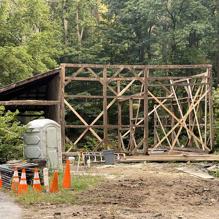 Rebuilding the barn, adding a roof and showing the delicate beams that look like a skeleton of the old barn.