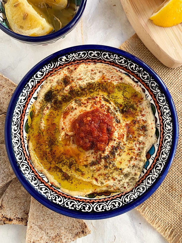 Two pictures showing preserved lemon hummus in the food processor and also plated and ready to serve.