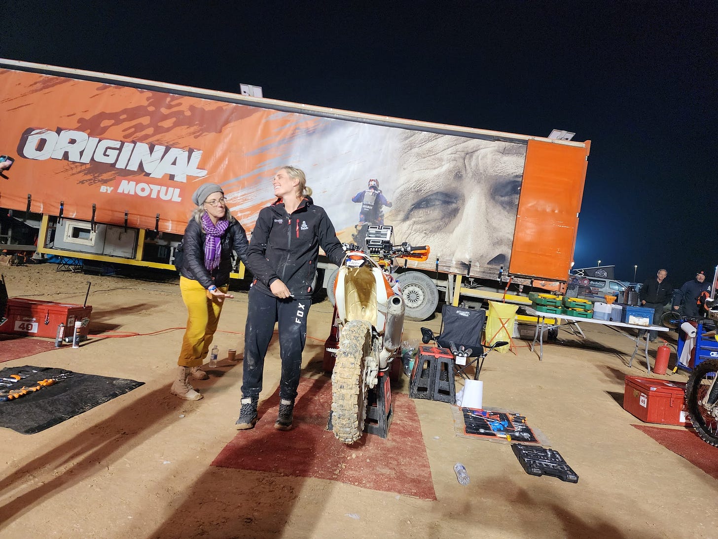Malle Moto Kirsten Landman standing next to her bike in the Original by Motul pits at the Dakar Rally, 2023. Malle Moto Kirsten Landman standing next to her bike in the Original by Motul pits at the Dakar Rally, 2023.