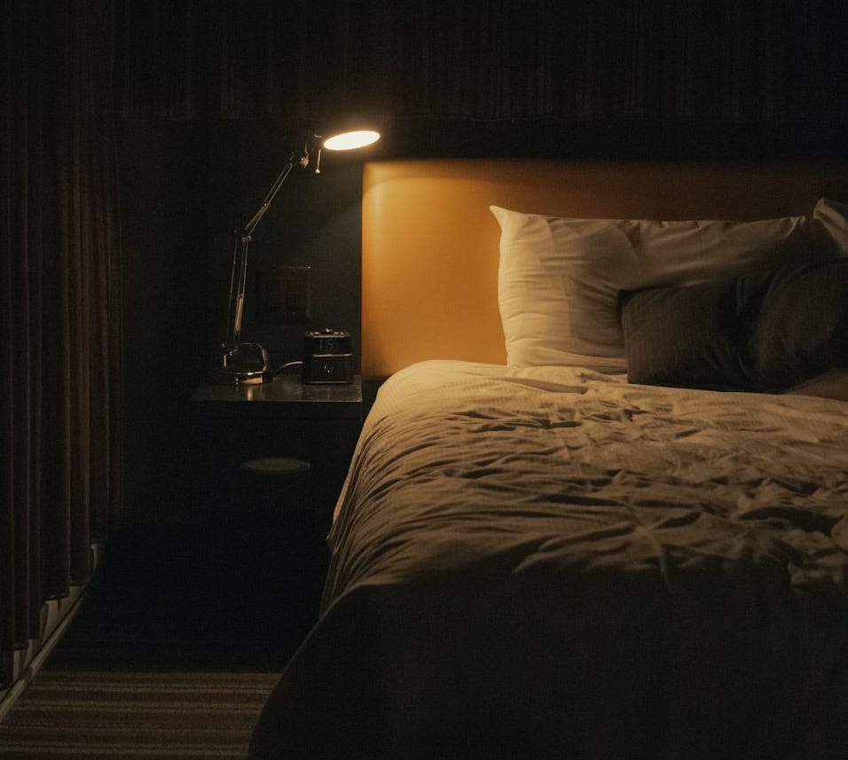 turned on study lamp beside bed