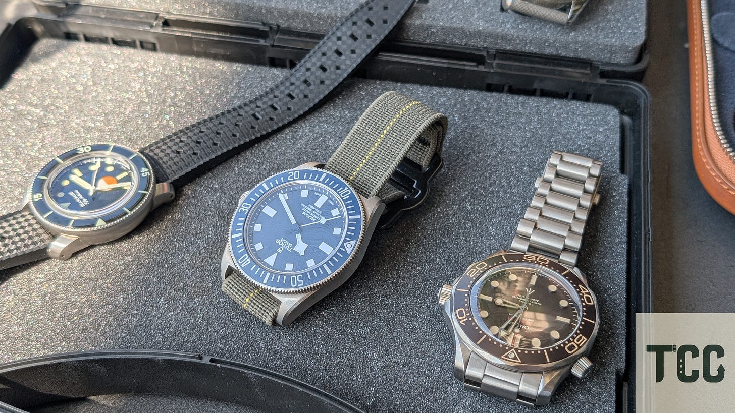 Three watches resting on an open case.