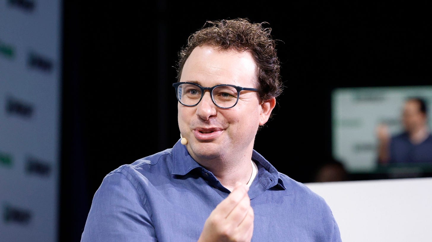 Dario Amodei talking on stage at a conference