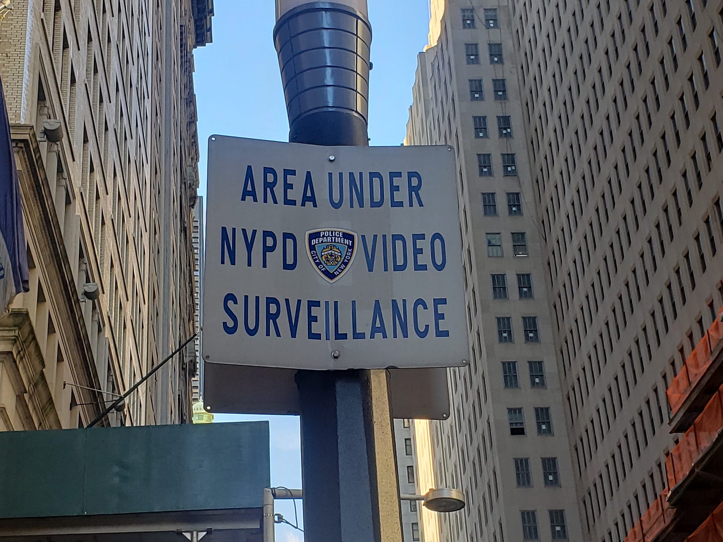 A photo of a sign with the NYPD shield, which states Area Under NYPD Video Surveillance A photo of a sign with the NYPD shield, which states Area Under NYPD Video Surveillance