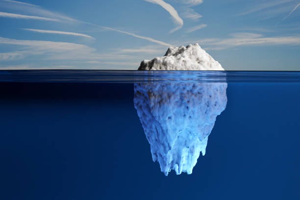 White iceberg exposing small part out of water and hiding most part under the ocean under blue sky. Illustration of the idiom of the tip of the iceberg White iceberg exposing small part out of water and hiding most part under the ocean under blue sky. Illustration of the idiom of the tip of the iceberg True Nature stock pictures, royalty-free photos & images