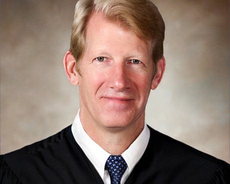 a man in judicial robes smiles a man in judicial robes smiles