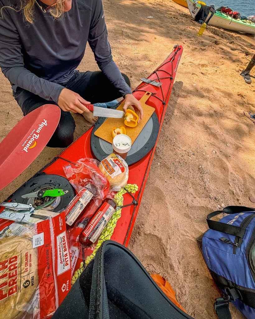 Making med wraps for lunch on a kayak trip