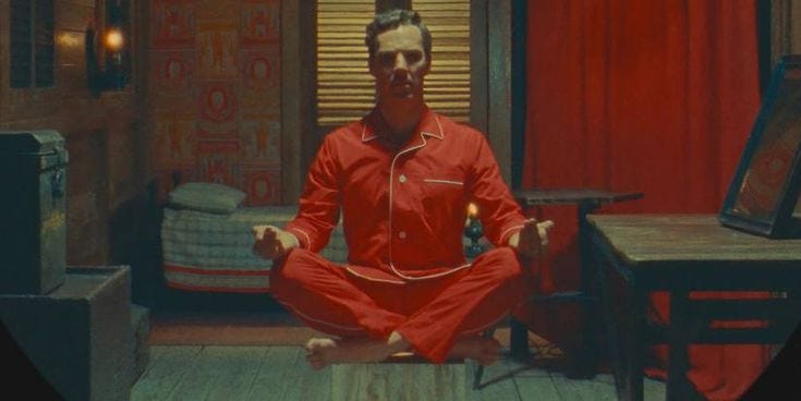 This may contain: a man in a red outfit is meditating