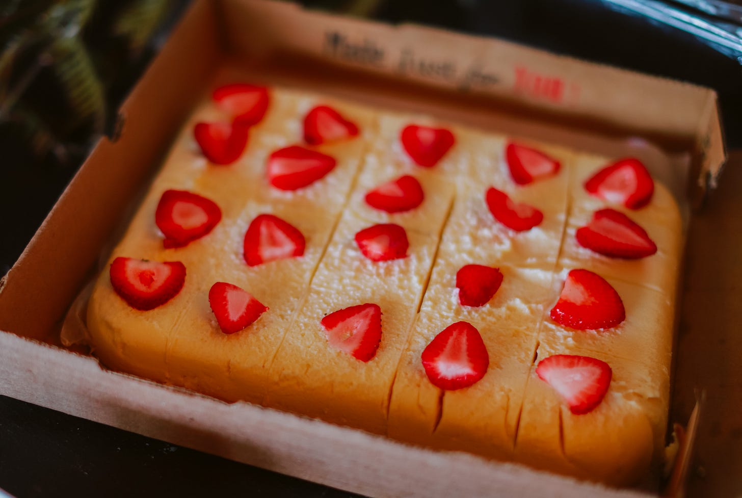 Strawberry shortcake with vibrant, red strawberries on top.
