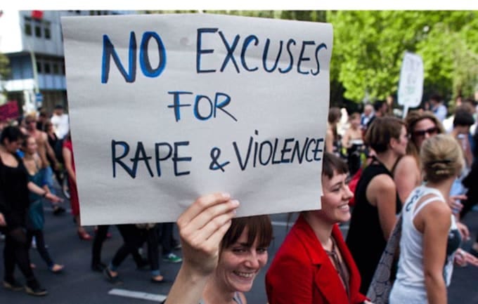 woman holding up an anti-rape slogan during march