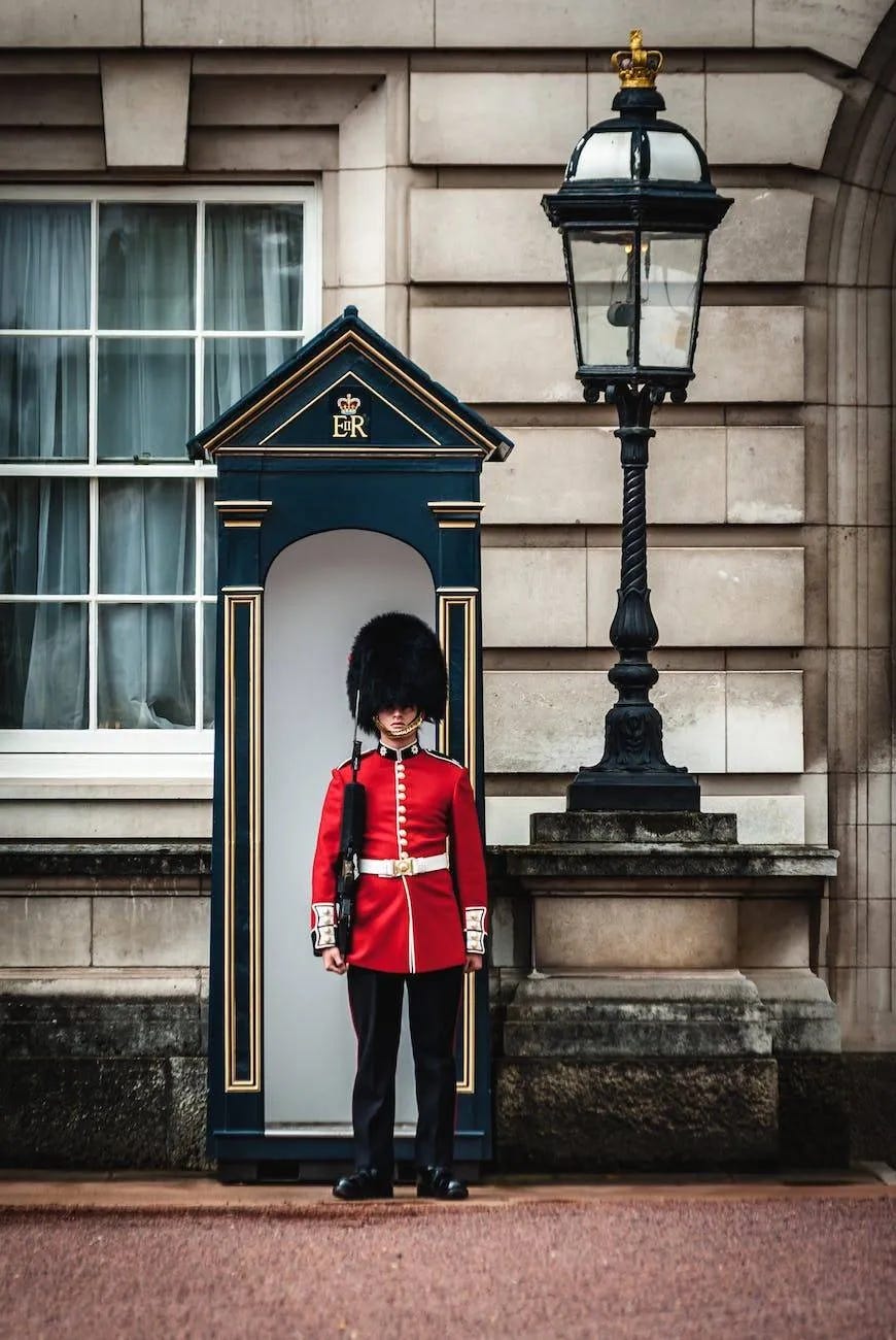 royal guard standing near lamp post royal guard standing near lamp post
