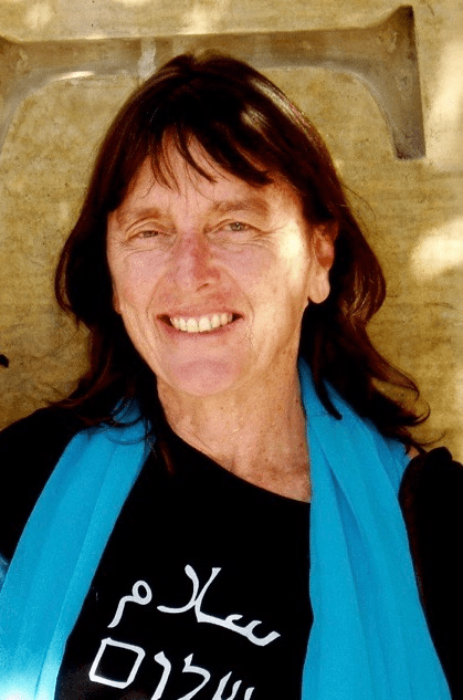 A person smiling at the camera Description automatically generated