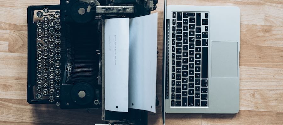 Typewriter next to Macbook