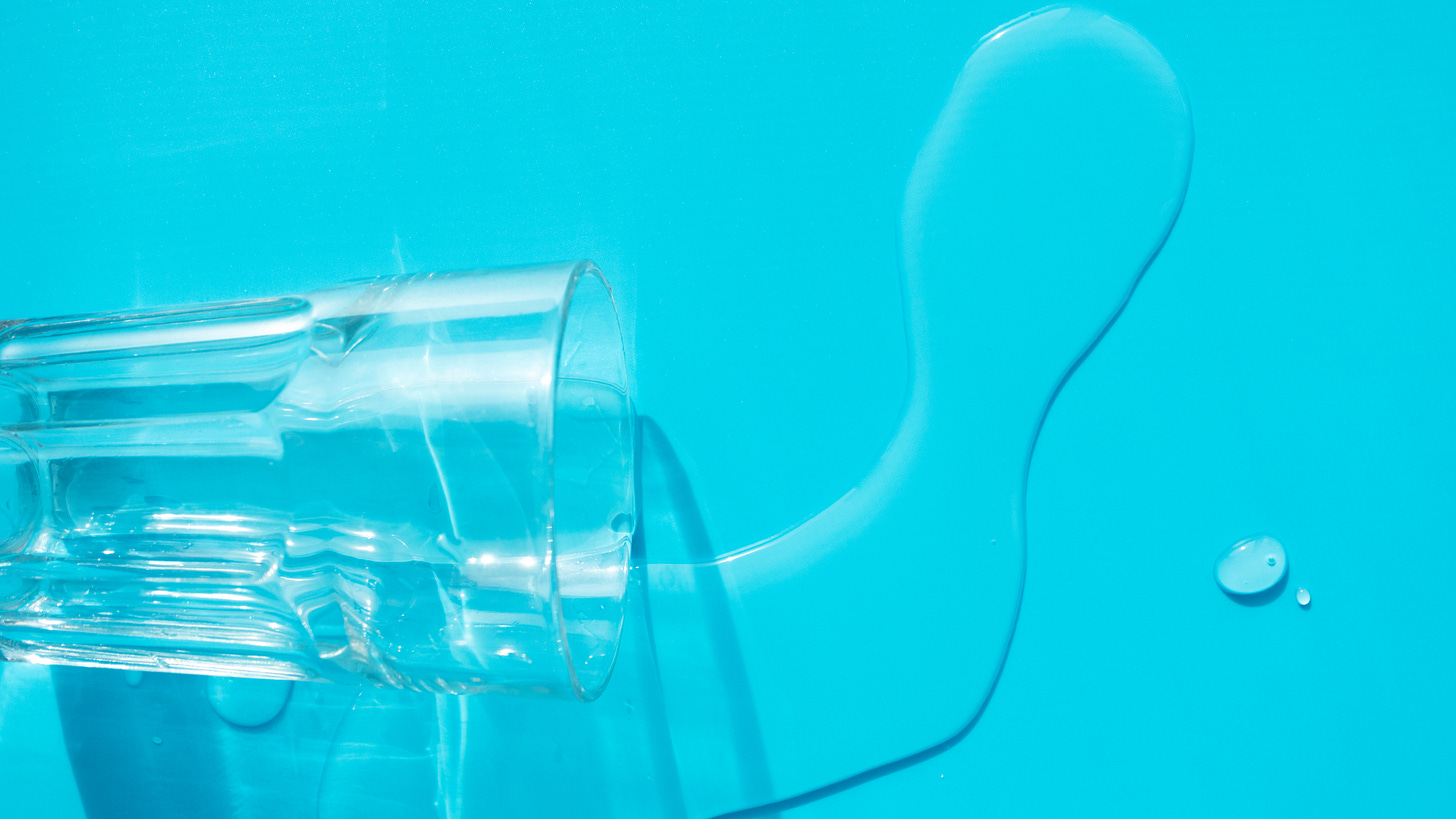 A photograph of water spilling from a glass