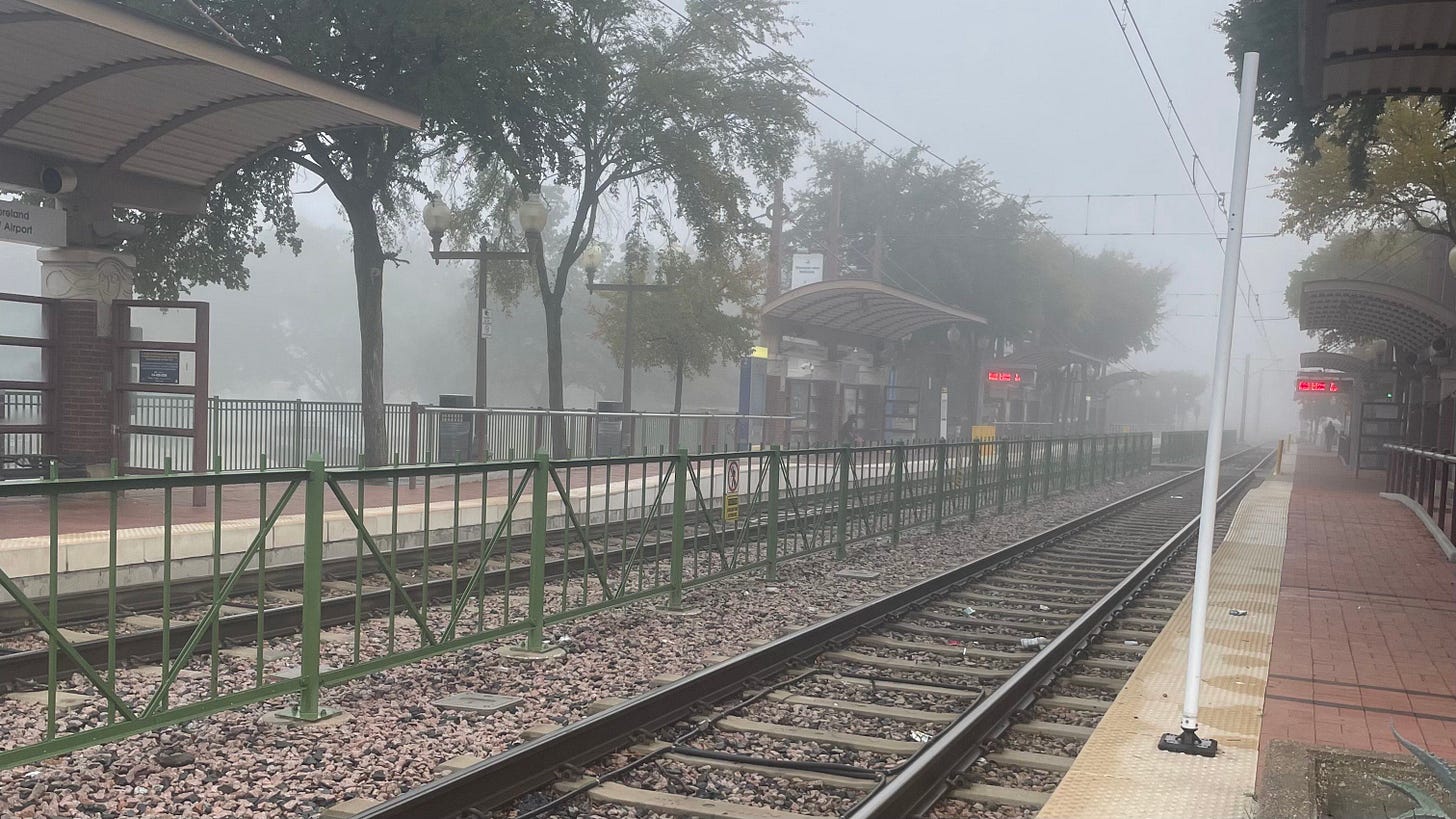 Downtown Plano Light Rail Station, the background and parts of the ground obscured by fog 