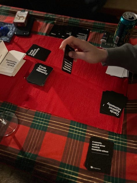 Holiday table setting, Cards Against Humanities, young man drinking coffee