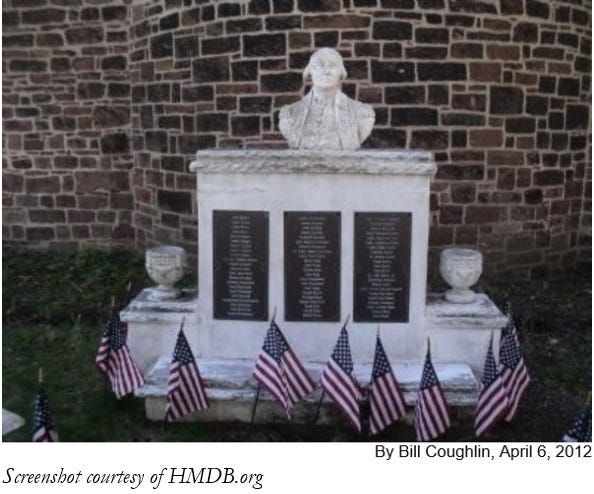 Monument commemorating the Battle of Fort Freeland.  American flags surround the monument.