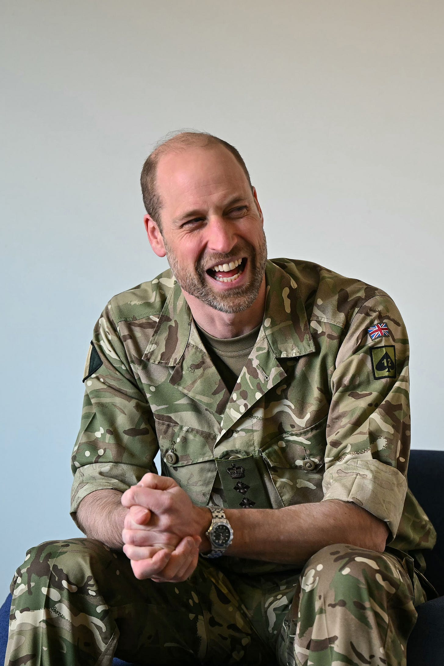 Prince William laughing wearing a camoflauge outfit Prince William laughing wearing a camoflauge outfit