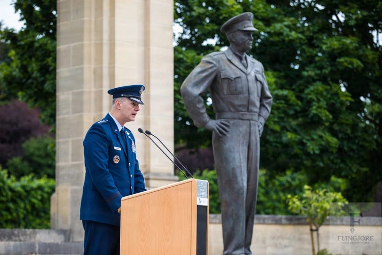 U.S. Air Force Gen. Alexus G. Grynkewich speaks from a podium during an Allied ceremony commemorating the 82nd anniversary of D-Day in Bayeux, France, with a military statue visible in the background. U.S. Air Force Gen. Alexus G. Grynkewich speaks from a podium during an Allied ceremony commemorating the 82nd anniversary of D-Day in Bayeux, France, with a military statue visible in the background.