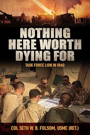 Book cover of Nothing Here Worth Dying For: Task Force Lion in Iraq by Col Seth W. B. Folsom, USMC (Ret.), featuring a photo of U.S. Marines gathered around a map in a desert tent setting, with a background image of armored vehicles and an explosion under a dramatic orange sky. Bold white and yellow title text overlays the imagery.