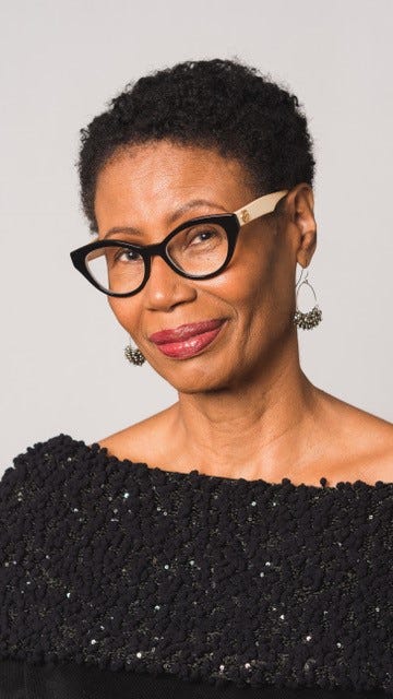 A woman smiles at the camera