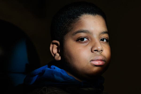 A portrait of Aissam Dam at the Children’s Hospital of Philadelphia. A beam of light illuminates his face.