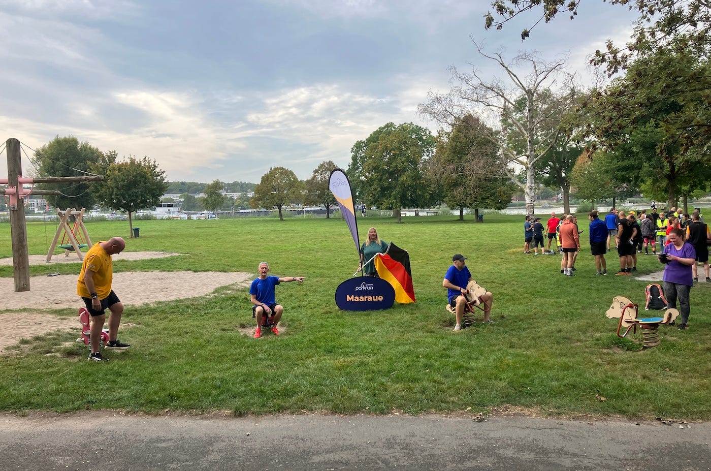 Posed picture on children bouncy metal horses in the playground with a flag in between Posed picture on children bouncy metal horses in the playground with a flag in between