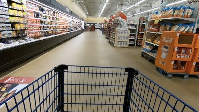 The shopper's perspective looking over a grocery store basket in an stocked but unoccupied store. The shopper's perspective looking over a grocery store basket in an stocked but unoccupied store.