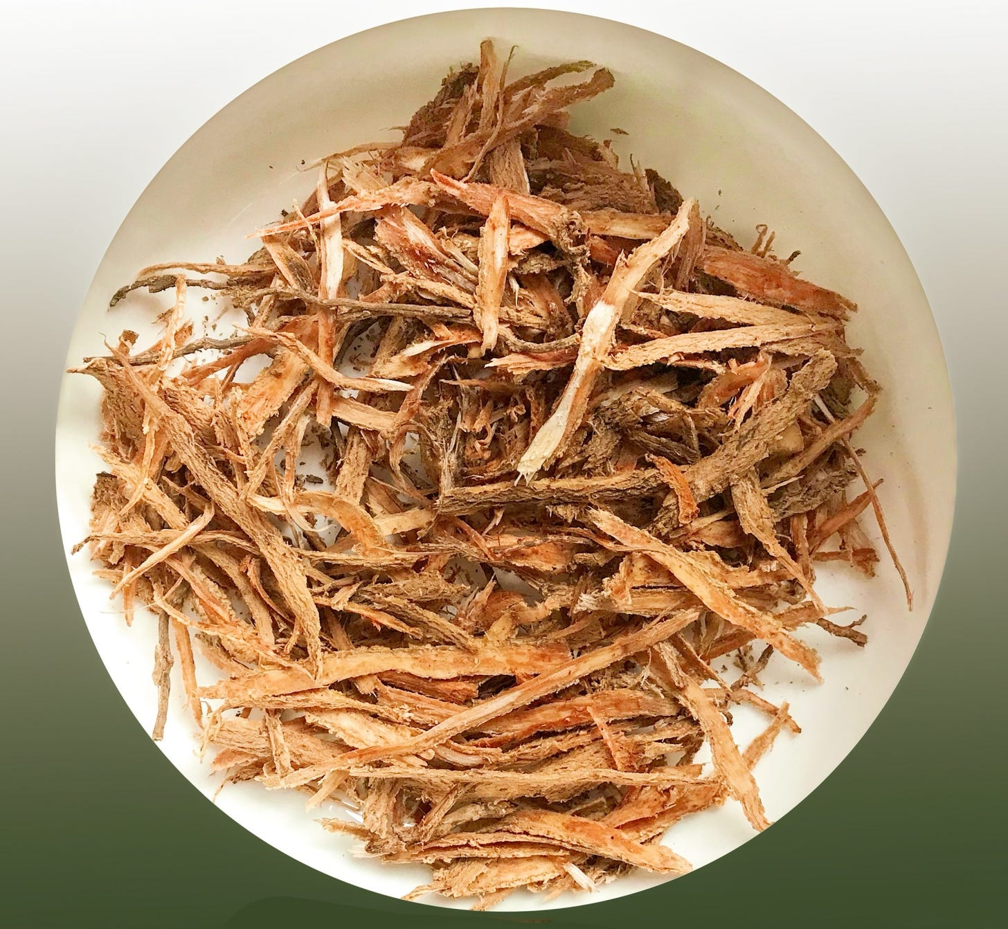 Flaky strips of reddish brown dried bark