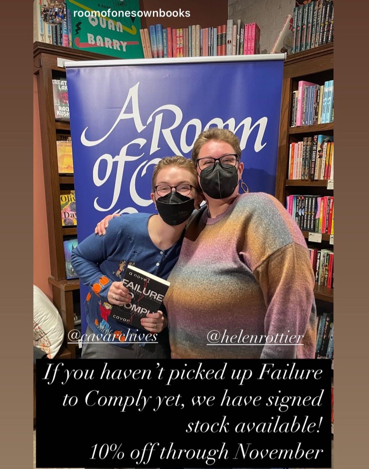 Cavar and Helen pose in front of an A Room of One's Own banner.