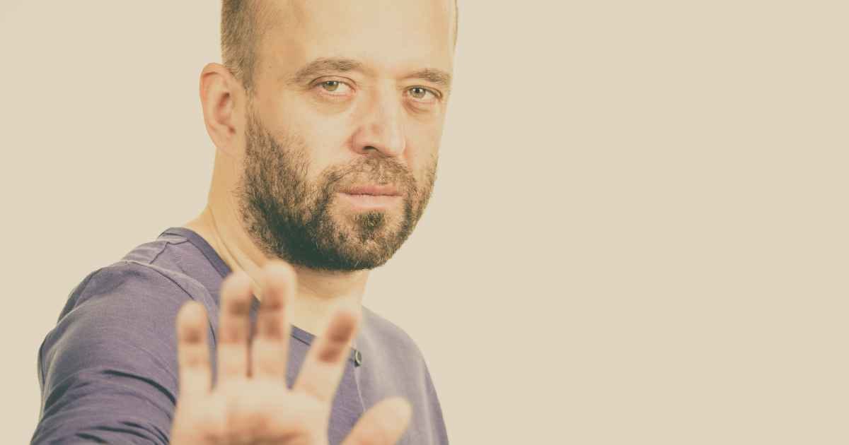 Man showing stop gesture with right hand Man showing stop gesture with right hand