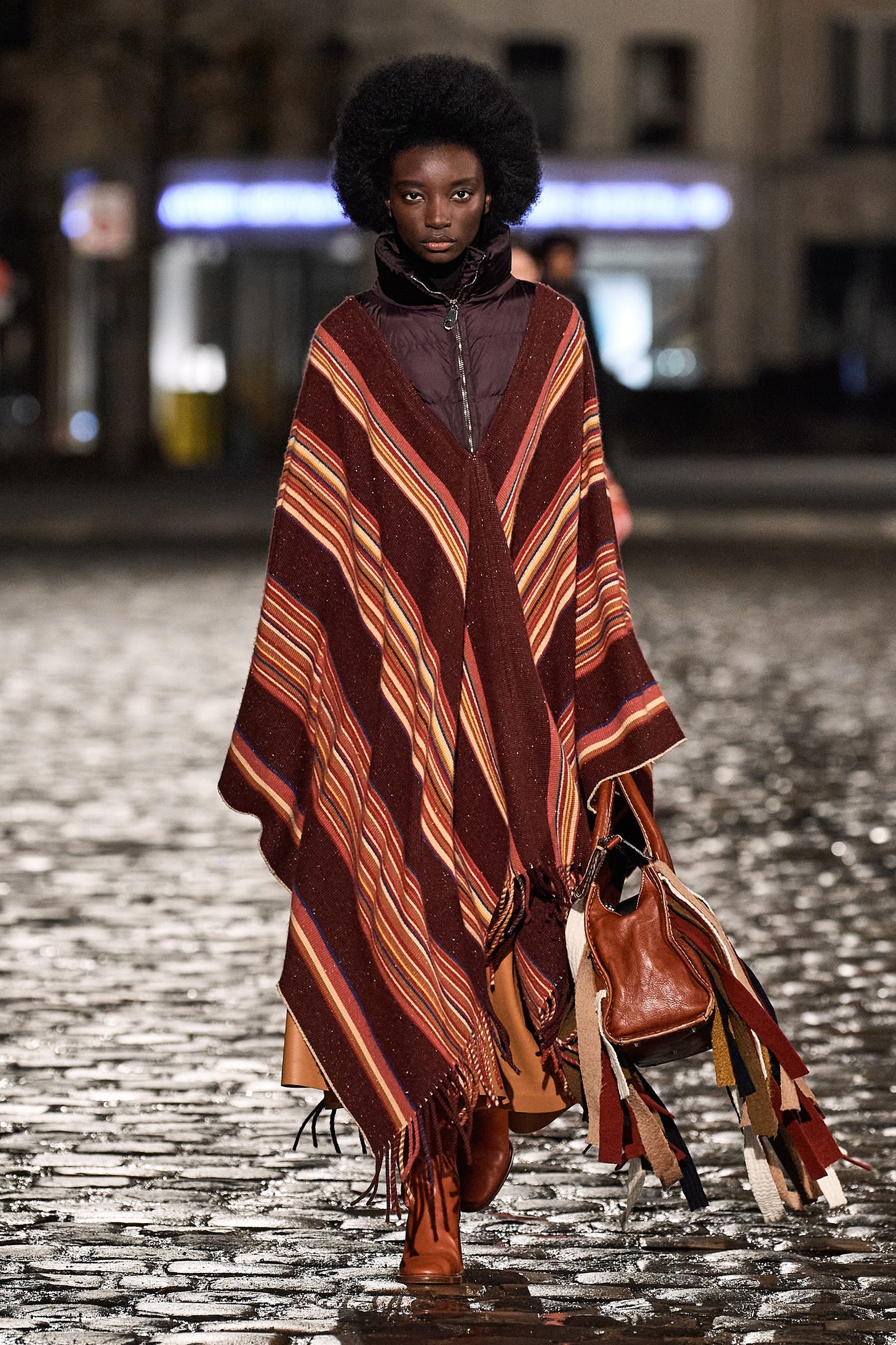 Image may contain Clothing Apparel Poncho Cloak Fashion Human and Person