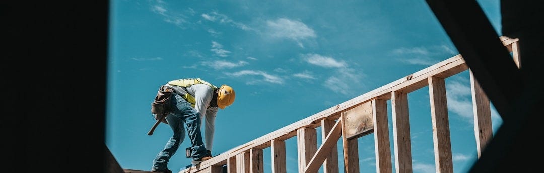 construction worker in hard hat on building frame
