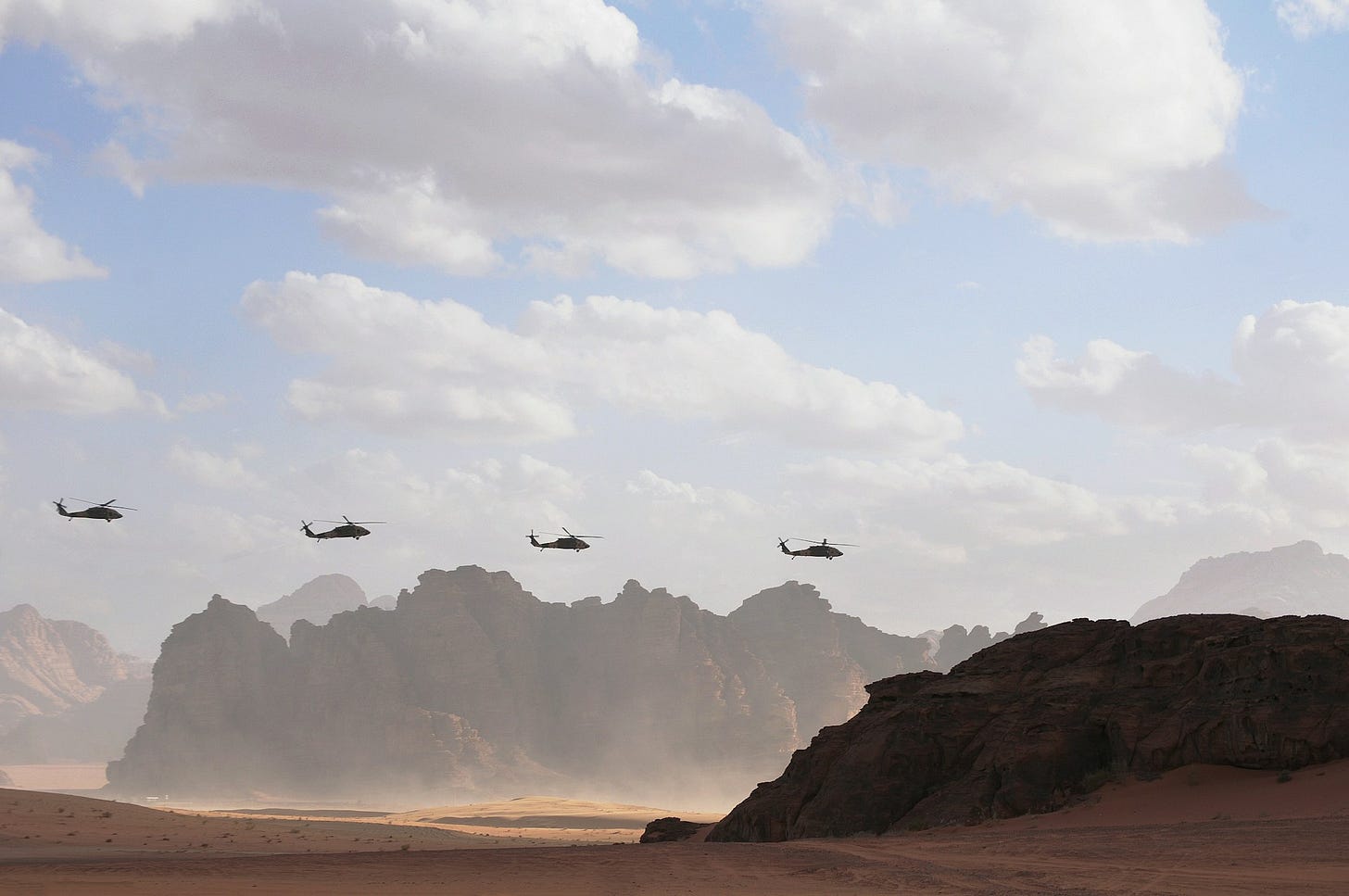 Military helicopters over the desert. Military helicopters over the desert.