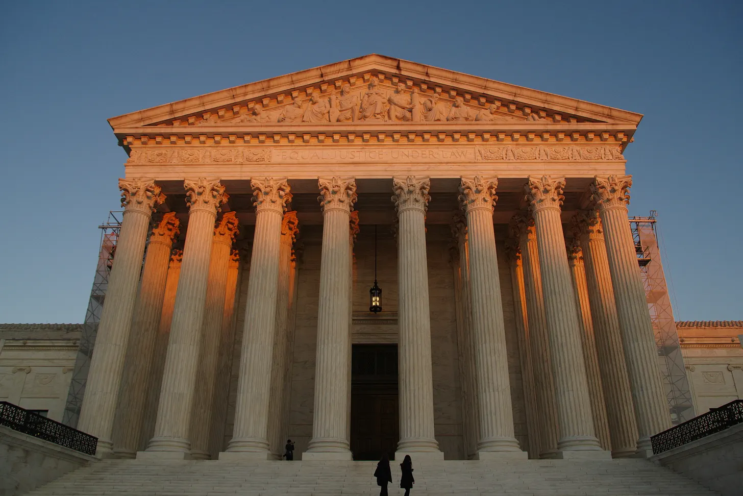 Supreme Court building columns with an American flag