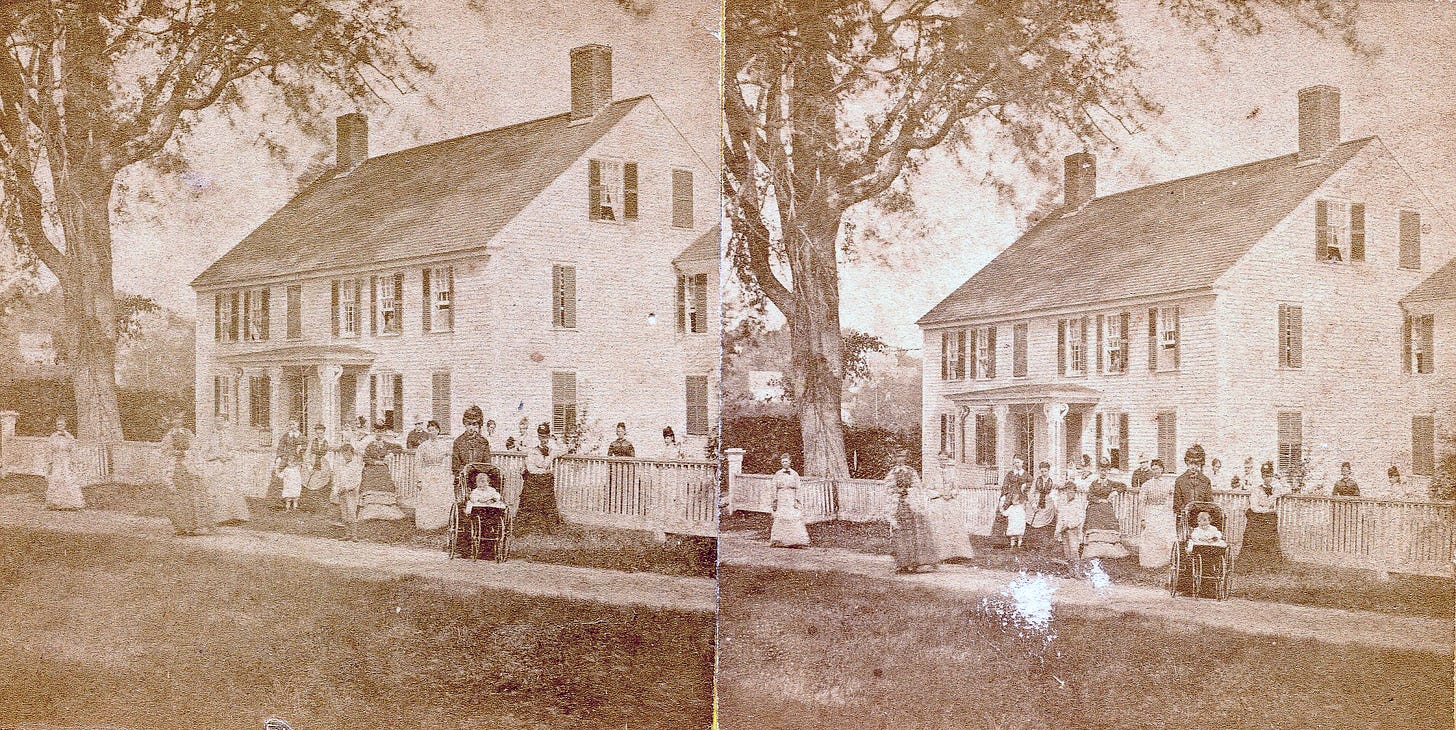 women and children in front of house