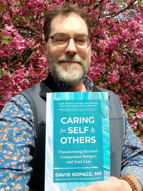 Author David Kopacz holding his book Caring for Self & Others. Author David Kopacz holding his book Caring for Self & Others.