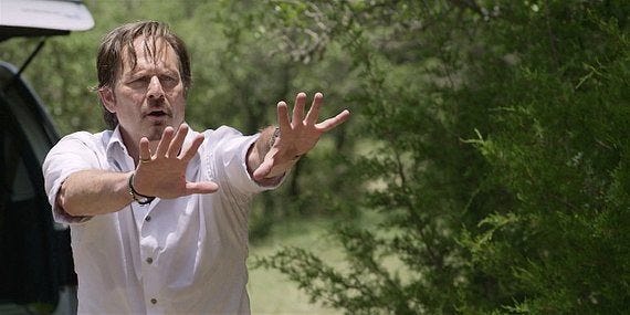 Walker Stan holding hands up to Cordell who has gun pointed at his head. Walker Stan holding hands up to Cordell who has gun pointed at his head.