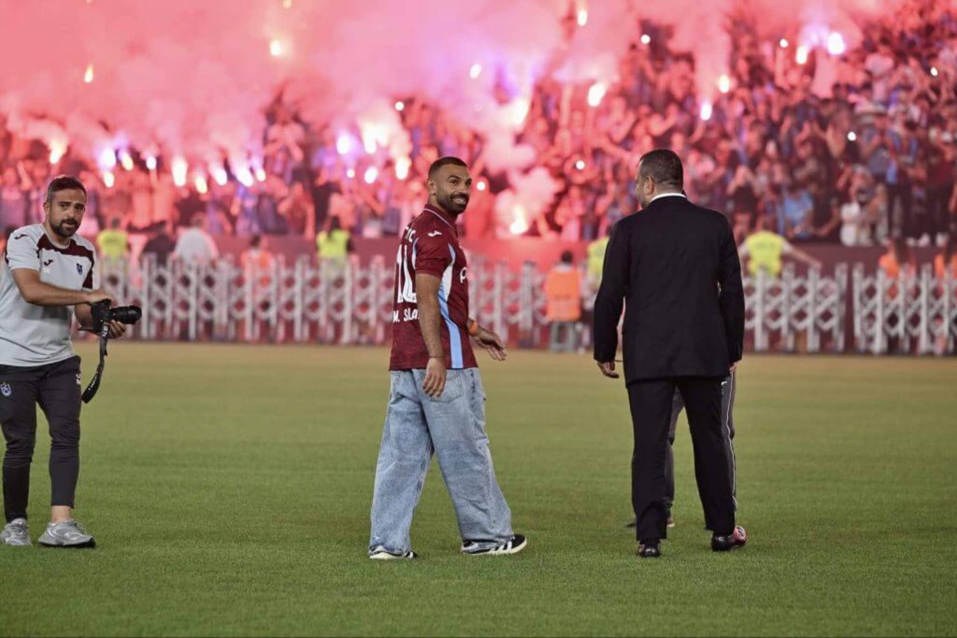 New signing Mohamed Salah being welcomed on the pitch at Turkish club Trabzonspor, with a backdrop of flare-waving fans and smoke New signing Mohamed Salah being welcomed on the pitch at Turkish club Trabzonspor, with a backdrop of flare-waving fans and smoke