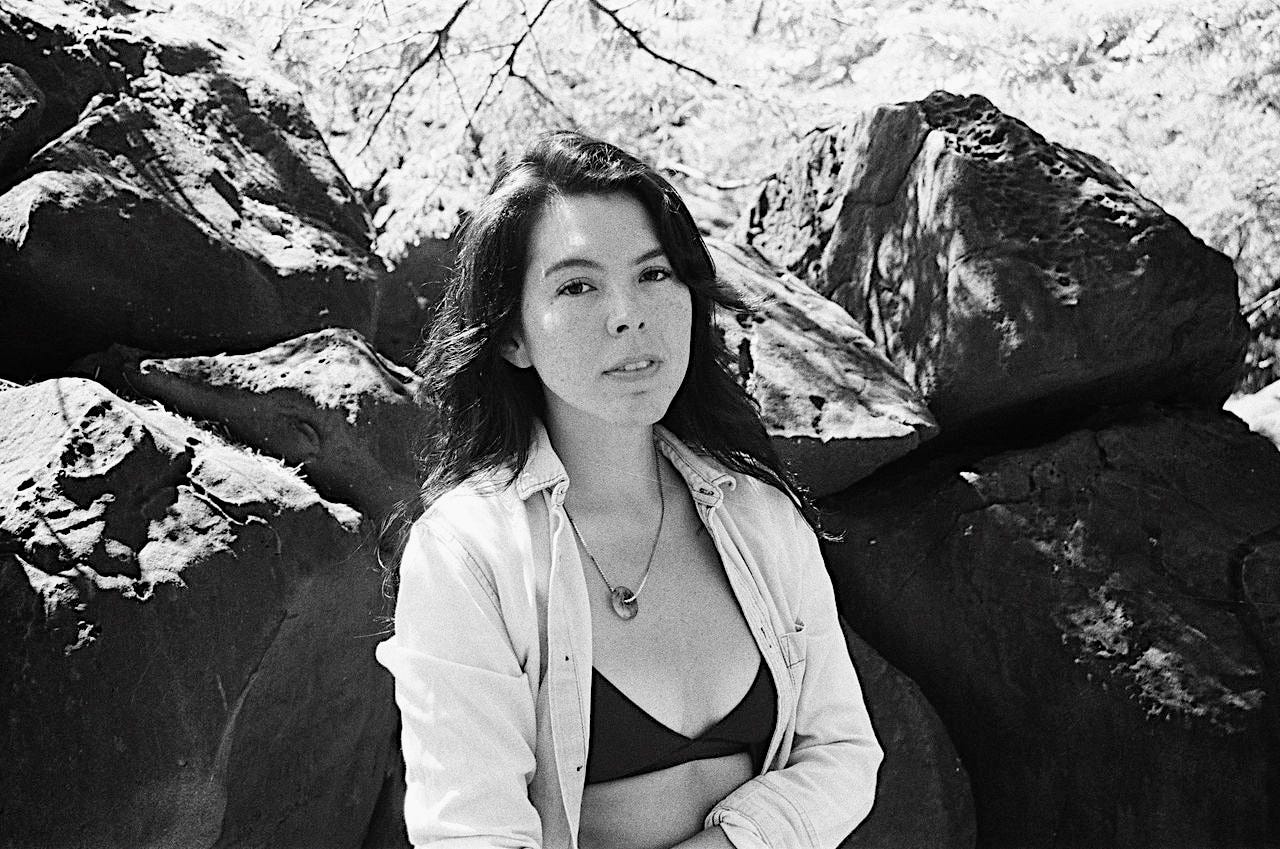 T Kira Madden in the sunshine with a rock backdrop